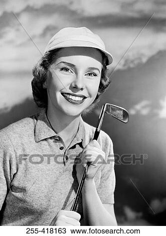 Stock Image - Smiling women with golf club. Fotosearch