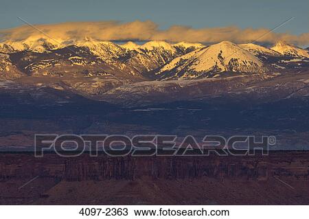 Stock Image - Snow covered mountains, La Sal Mountains, Buck Canyon Overlook, Canyonlands National Park, Utah, USA. Fotosearch