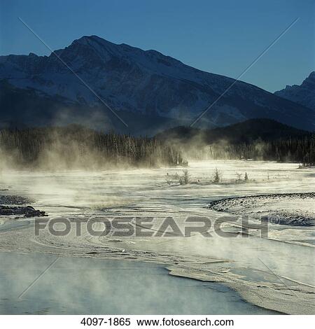 Stock Photography - Steam emerging from a hot spring, Jasper National Park, Alberta, Canada. Fotosearch