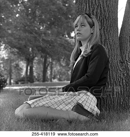 Student girl sitting under tree View Large Photo Image Stock Photo - Student girl sitting under tree. Fotosearch
