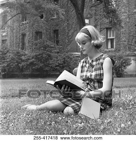 Student sitting on grass and reading book View Large Photo Image Stock Photo - Student sitting on grass and reading book. Fotosearch