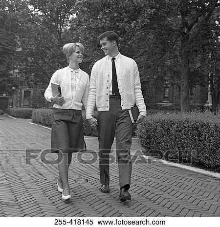 Stock Photography - Students couple walking in park. Fotosearch