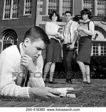 Students watching friend reading on grass outside university View Large Photo Image Stock Image - Students watching friend reading on grass outside university. Fotosearch