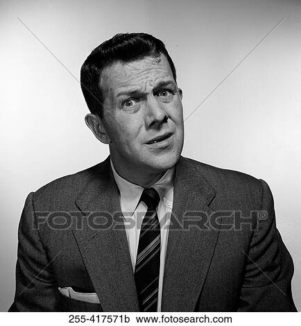 Stock Image - Studio portrait mid adult man. Fotosearch