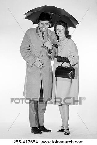 Studio portrait of couple under umbrella View Large Photo Image Picture - Studio portrait of couple under umbrella. Fotosearch
