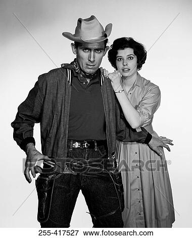 Studio portrait of cowboy defending girlfriend View Large Photo Image Stock Photo - Studio portrait of cowboy defending girlfriend. Fotosearch