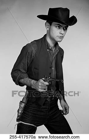 Studio portrait of cowboy with gun View Large Photo Image Stock Image - Studio portrait of cowboy with gun. Fotosearch