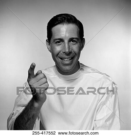 Stock Image - Studio portrait of doctor pointing. Fotosearch