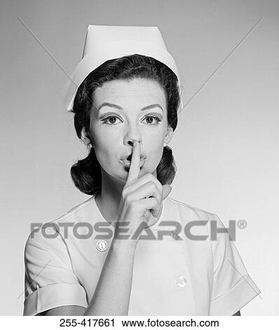 Studio portrait of female nurse gesturing silence View Large Photo Image Stock Image - Studio portrait of female nurse gesturing silence. Fotosearch