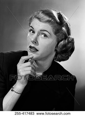 Stock Image - Studio portrait of mid adult woman. Fotosearch
