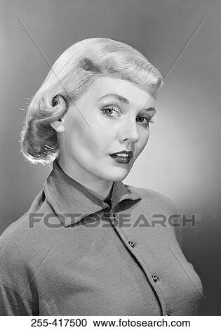 Stock Image - Studio portrait of mid adult woman. Fotosearch