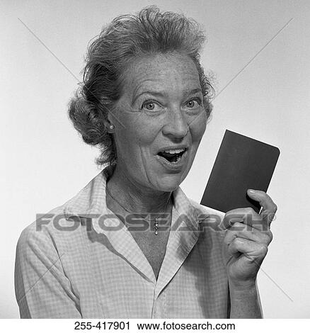 Studio portrait of senior woman holding passport View Large Photo Image Stock Image - Studio portrait of senior woman holding passport. Fotosearch