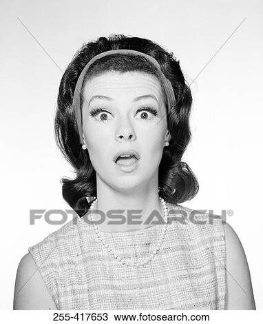 Stock Image - Studio portrait of shocked young woman. Fotosearch