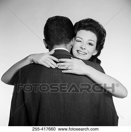 Studio portrait of woman embracing husband View Large Photo Image Stock Image - Studio portrait of woman embracing husband. Fotosearch