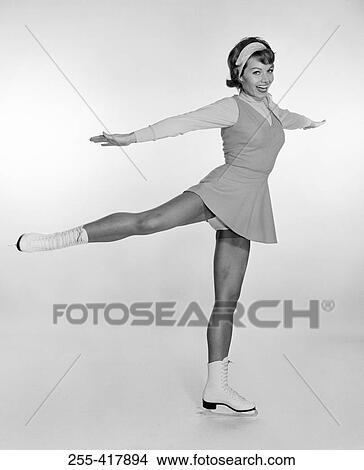 Picture - Studio portrait of young woman ice skating. Fotosearch