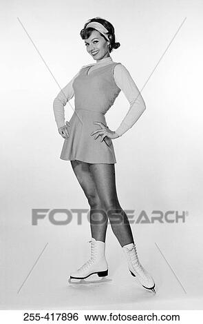 Stock Photograph - Studio portrait of young woman ice skating. Fotosearch