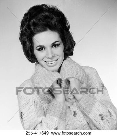 Studio portrait of young woman in jumper View Large Photo Image Stock Photo - Studio portrait of young woman in jumper. Fotosearch