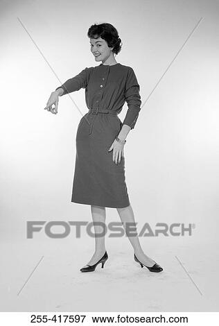 Stock Photo - Studio portrait of young woman pointing. Fotosearch