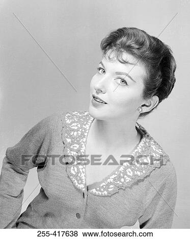Stock Photo - Studio portrait of young woman smiling. Fotosearch