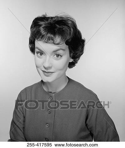 Stock Photography - Studio portrait of young woman smiling. Fotosearch