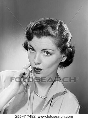 Stock Image - Studio portrait of young woman. Fotosearch