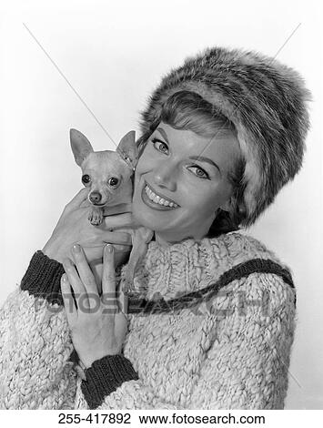 Studio portrait of young woman embracing dog View Large Photo Image Stock Image - Studio portrait of young woman embracing dog. Fotosearch