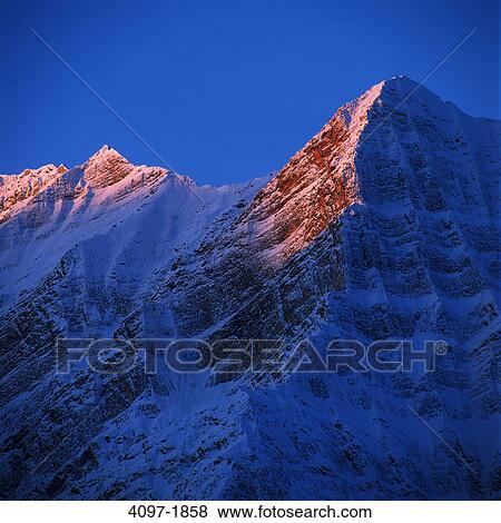 Sunlight on snowcapped mountain peak, Jasper National Park, Alberta, Canada View Large Photo Image Stock Photo - Sunlight on snowcapped mountain peak, Jasper National Park, Alberta, Canada. Fotosearch