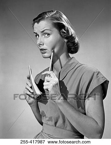 Thoughtful young woman holding pen and notepad View Large Photo Image Stock Photo - Thoughtful young woman holding pen and notepad. Fotosearch