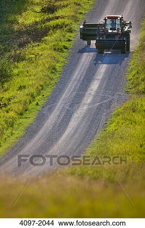 Picture - Tractor on a road, Alberta, Canada. Fotosearch