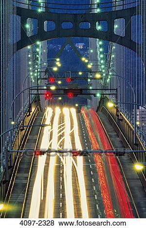 Stock Photo - Traffic on a suspension bridge at dusk, Lions Gate Bridge, Vancouver, British Columbia, Canada. Fotosearch