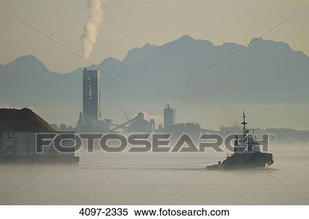Tugboat with industrial buildings at the riverside, Fraser River, Vancouver, British Columbia, Canada View Large Photo Image Stock Photography - Tugboat with industrial buildings at the riverside, Fraser River, Vancouver, British Columbia, Canada. Fotosearch