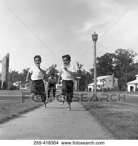 Twin boys running on pavement View Large Photo Image Picture - Twin boys running on pavement. Fotosearch