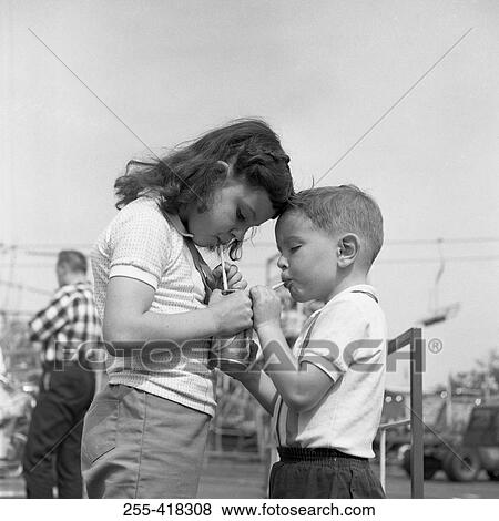 Stock Photo - Two kids drinking cola. Fotosearch