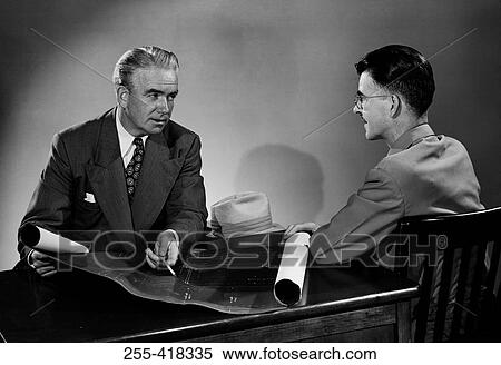 Stock Photography - Two men discussing architectural paln. Fotosearch