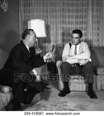 Two men talking in living room View Large Photo Image Stock Image - Two men talking in living room. Fotosearch