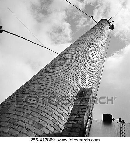 Stock Photo - USA, New England, Vermont, Hoosick Falls, Wood and pulp mill smoke stack. Fotosearch