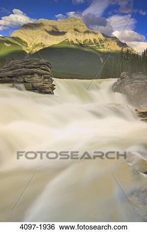 Stock Photograph - Waterfall with a mountain in the background, Athabasca Falls, Mt Kerkeslin, Jasper National Park, Alberta, Canada. Fotosearch