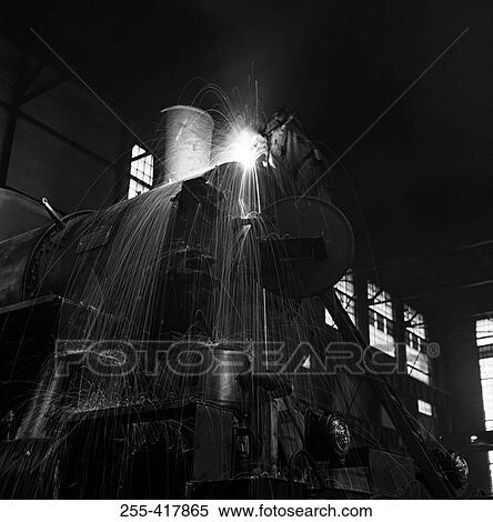 Stock Photography - Welder working on steam train. Fotosearch
