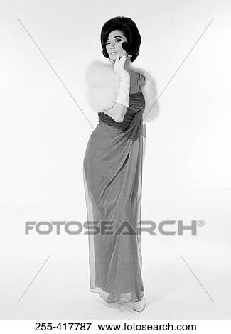 Stock Photo - Woman in evening dress, fur stole and gloves, studio shot. Fotosearch