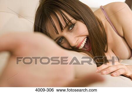 Stock Photograph - Woman in underwear and smiling, Manhattan, New York City, New York State, USA. Fotosearch
