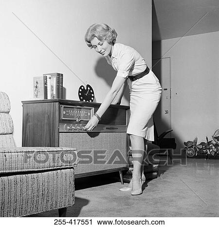 Woman listening to radio in living room View Large Photo Image Stock Image - Woman listening to radio in living room. Fotosearch