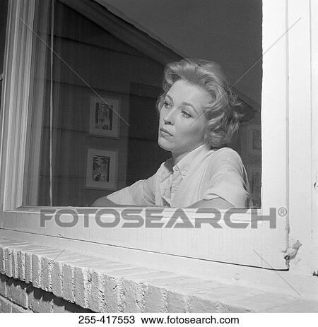 Woman looking out window View Large Photo Image Stock Image - Woman looking out window. Fotosearch