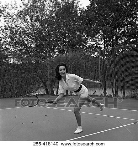 Stock Image - Woman playing tennis. Fotosearch