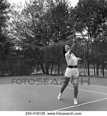 Stock Photo - Woman playing tennis. Fotosearch