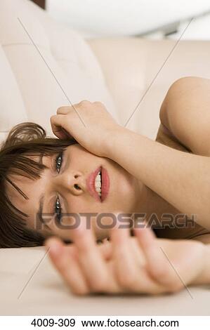 Woman posing on a sofa, Manhattan, New York City, New York State, USA View Large Photo Image Stock Photo - Woman posing on a sofa, Manhattan, New York City, New York State, USA. Fotosearch