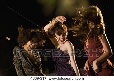 Stock Photo - Women dancing in a party on rooftop, Manhattan, New York City, New York State, USA. Fotosearch
