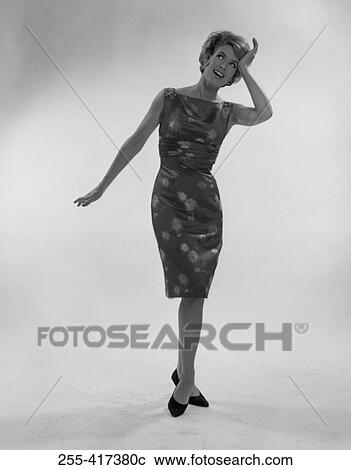 Stock Image - Young and happy young woman, studio shot. Fotosearch