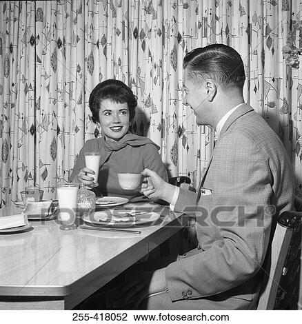 Stock Image - Young couple having supper. Fotosearch