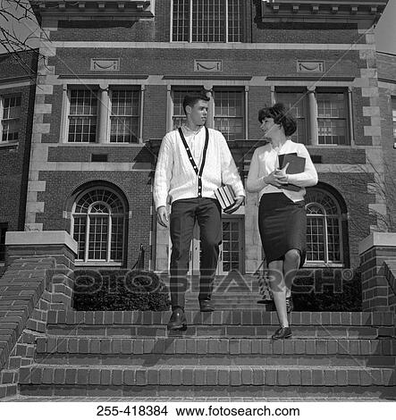 Picture - Young couple on steps outside university. Fotosearch