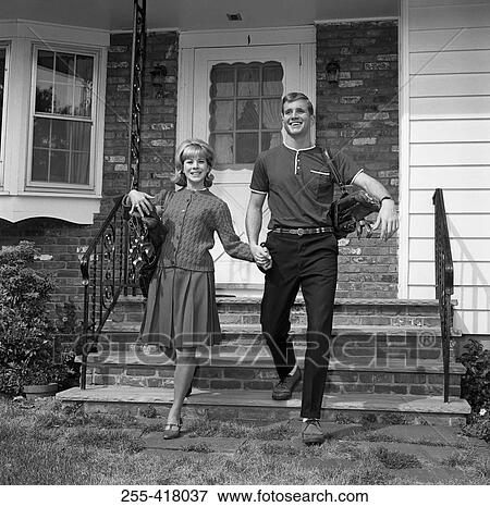 Young couple walking out of home View Large Photo Image Stock Photo - Young couple walking out of home. Fotosearch
